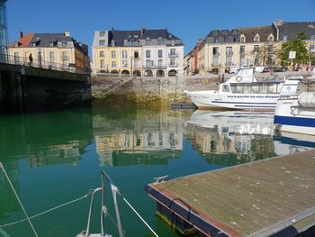 Canal amidst buildings in city against sky