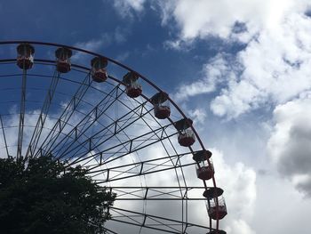 Low angle view of ferris wheel against sky