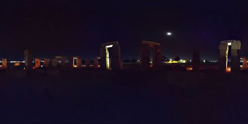 Illuminated cityscape against sky at night