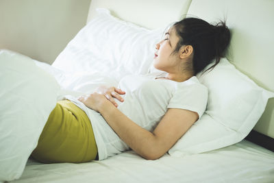 Young woman lying on bed