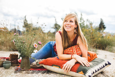 Portrait of a smiling young woman sitting outdoors