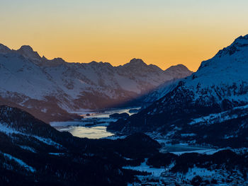 Scenic view of snowcapped mountains against sky during sunset