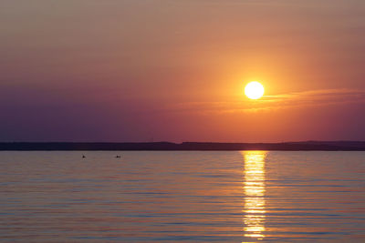 Scenic view of sea against orange sky