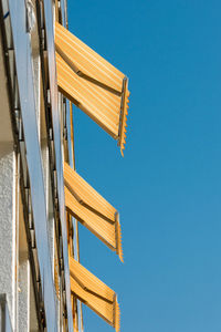 Low angle view of building against clear blue sky