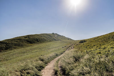 Low angle view of trail on hill against sky
