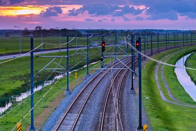 High angle view of train on field against sky during sunset