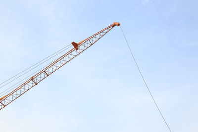 Low angle view of crane against sky