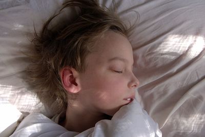 High angle view of baby sleeping on bed at home