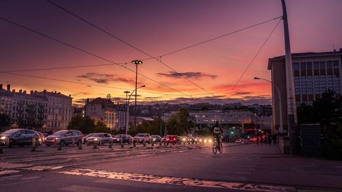 City street against sky during sunset