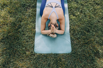 High angle view of woman doing yoga on a mat 