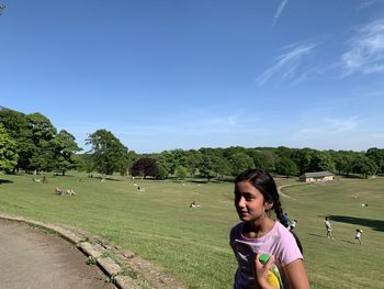 Woman on field against sky