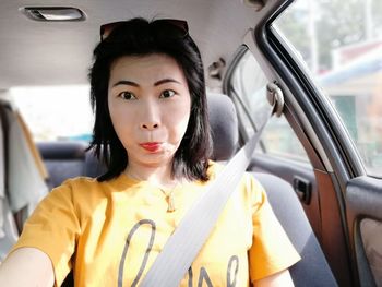 Portrait of woman sitting in car