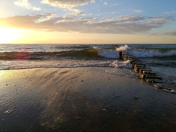 Scenic view of beach against sky during sunset