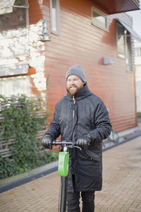 Man holding electric scooter