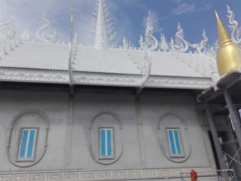 Low angle view of building seen through glass window