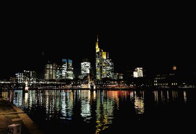 Illuminated city at waterfront