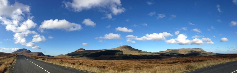 Panoramic view of road amidst mountains against sky