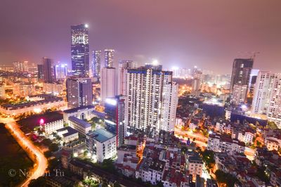 High angle view of illuminated buildings in city at night