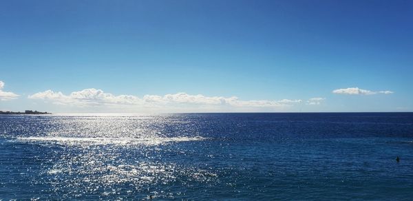 Scenic view of sea against blue sky