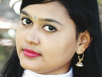 Close-up portrait of young woman wearing pink lipstick