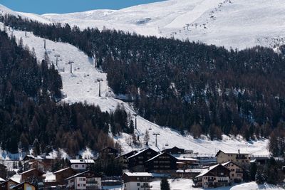 Aerial view of snow covered land and mountains