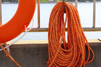 Close-up of ropes on railing against sea