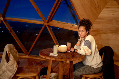 Relaxed woman inside a dome tent.