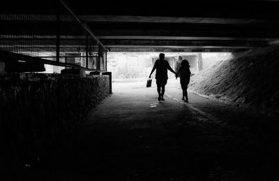 Silhouette people walking in corridor