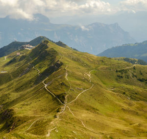 Scenic view of mountains against cloudy sky