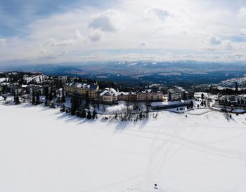 High angle view of snow covered city against sky