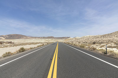 Empty road against sky