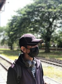 Portrait of man standing against trees