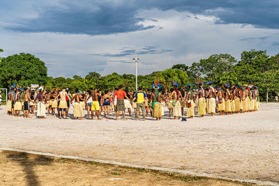 Group of people by plants against the sky