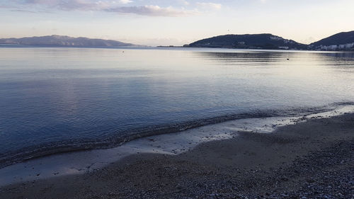 Scenic view of beach against sky during sunset