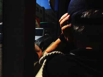 Close-up of man using mobile phone in car