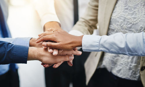 Business people stacking hands