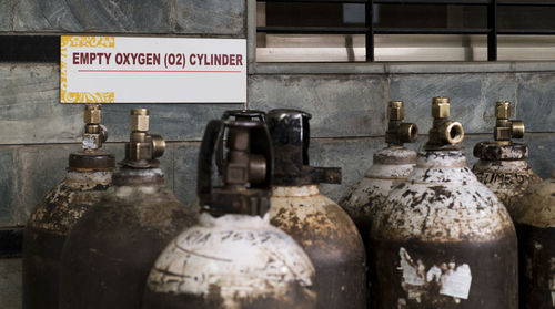 Close-up of old bottles against wall