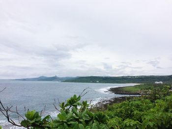 Scenic view of sea against cloudy sky