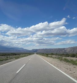 Road by landscape against sky