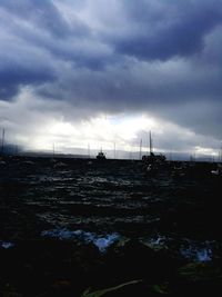 Scenic view of river against cloudy sky