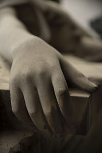 Close-up of hand lying down