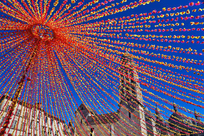 Low angle view of multi colored buildings against blue sky