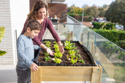 Mother and son working on a urban garden at home