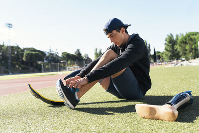 Man wearing shoe on running track