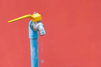 Close-up of faucet against wall