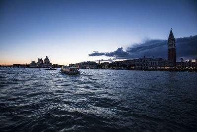 Boats in san marco canal at st marks square against sky during sunset