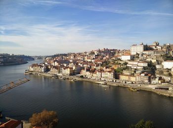 High angle view of townscape by sea against sky