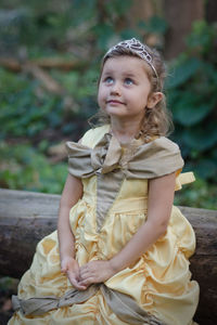 Portrait of smiling girl sitting outdoors