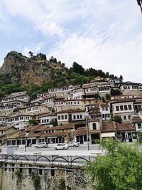 Buildings in town against sky