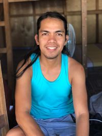 Portrait of smiling young man sitting at home